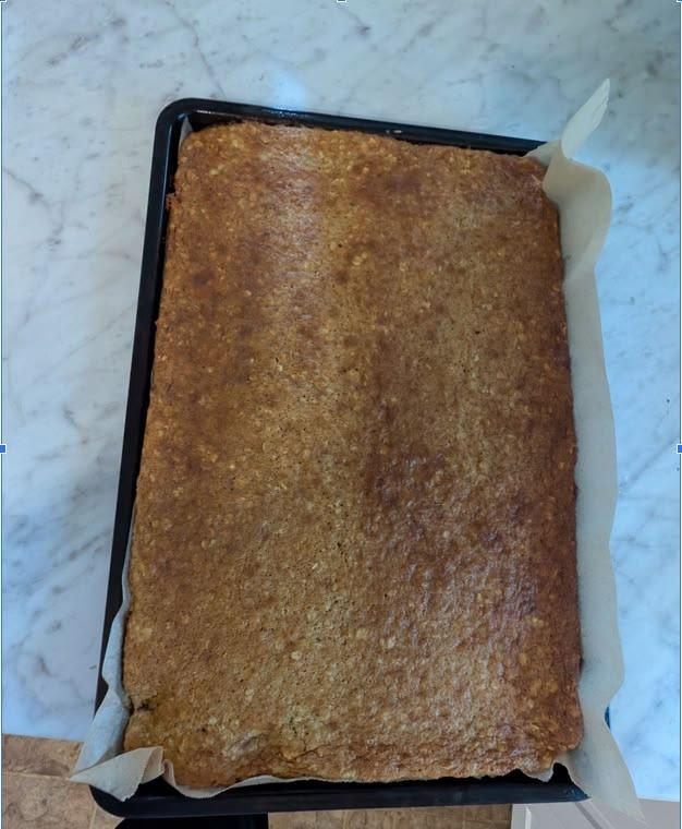 Soft baked breakfast bars sliced into squares on a sheet pan.