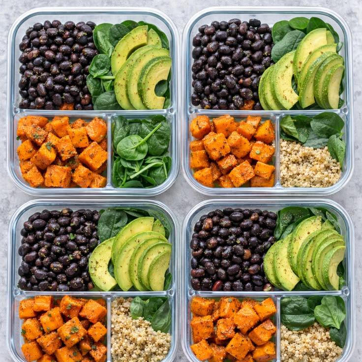 Meal prep bowls with sweet potatoes, quinoa, beans, and avocado.