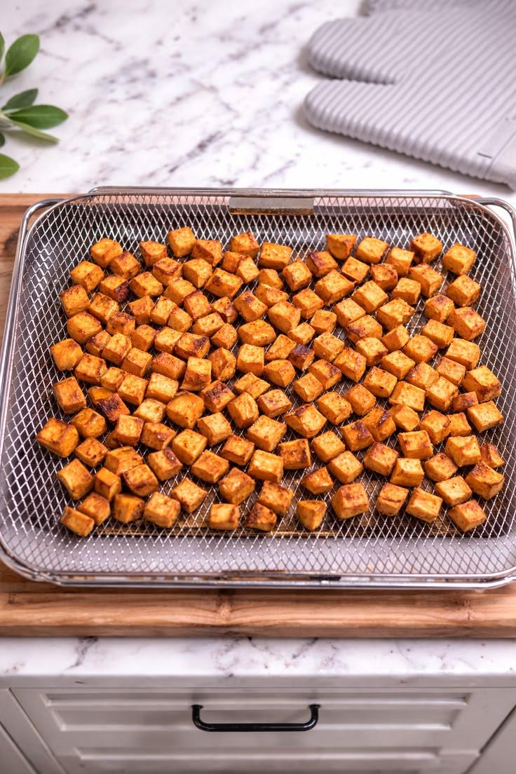 Tray of crispy roasted sweet potato cubes.